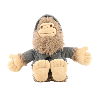 Plush toy resembling a sasquatch with a gray sweater on a white background