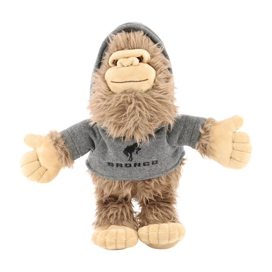 Plush toy resembling a sasquatch wearing a gray hoodie with 'Bronco' branding on a white background