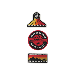 A set of three Ford Bronco patches with varying designs, mounted on a display card. The patches feature the Bronco logo and the phrases 'Built Wild' and 'Free Wheeling'.