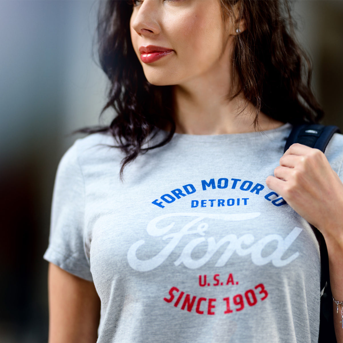 Woman wearing a gray t-shirt with Ford Motor Co branding