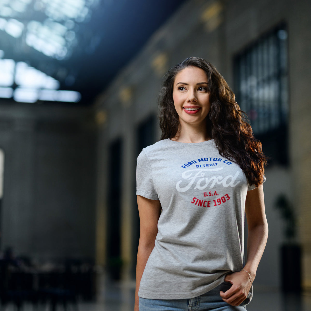 Woman wearing a gray Ford t-shirt in an indoor setting