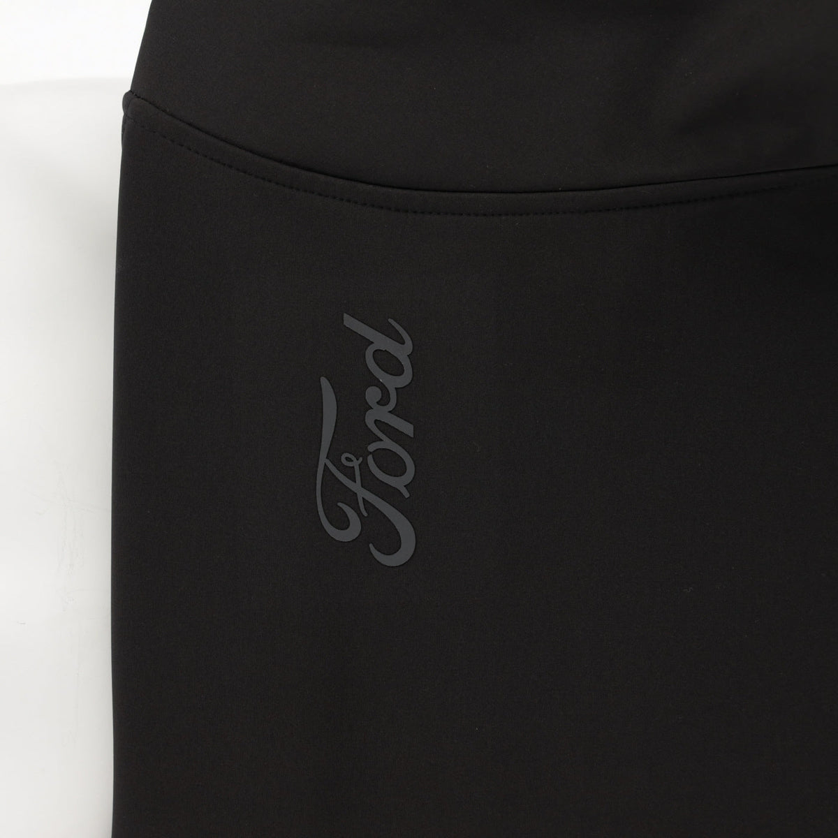 close up of ford script on sleeve on black background