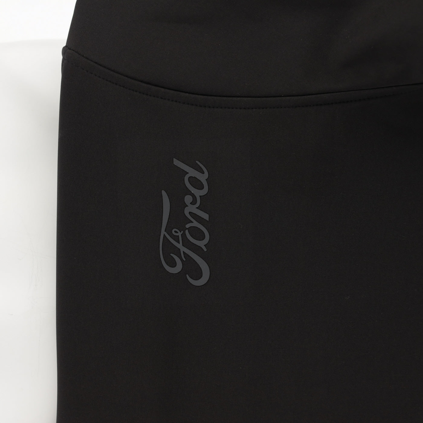 close up of ford script on sleeve on black background