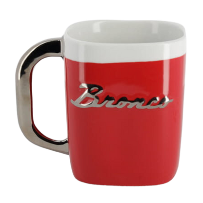 A red and white coffee mug with 'Bronco' text on the side.