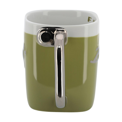 Green mug with a silver handle on a white background
