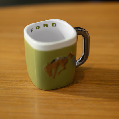 Green mug with Bronco horse design and 'FORD' branding on a wooden surface