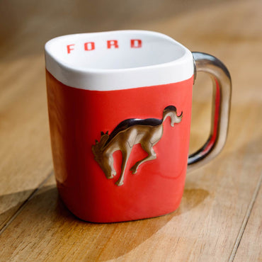 Red mug with a horse emblem and 'Ford' branding on a wooden surface