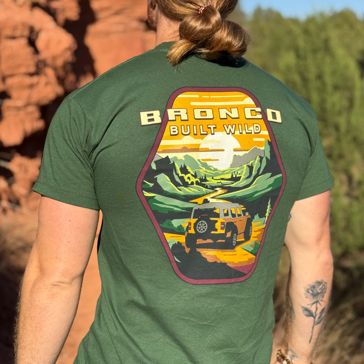 man outdoors wearing a bronco built wild t-shirt with a vintage graphic. 