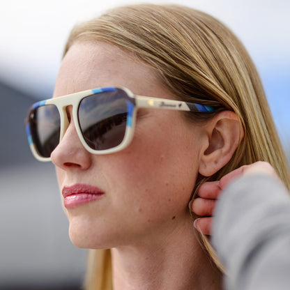 Close-up of a person wearing sunglasses with a blurred background