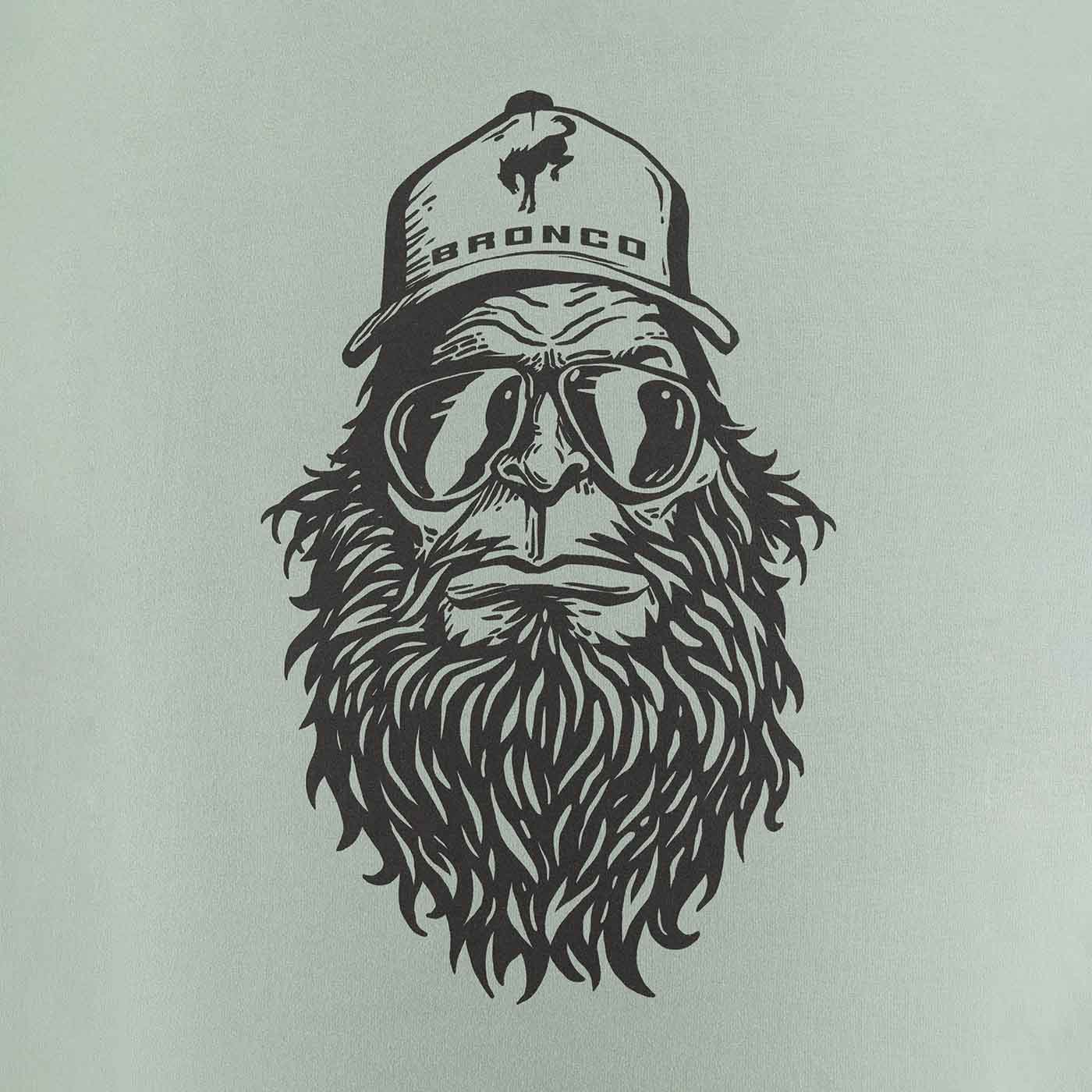 up close sasquatch graphic in sunglasses with bronco hat on mint green background