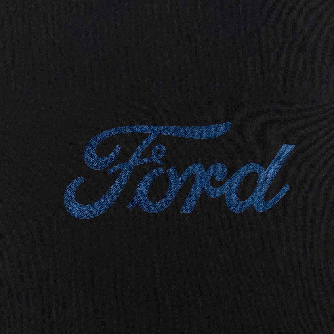 close up of foil blue ford script on black background