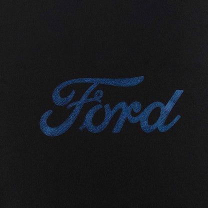 close up of foil blue ford script on black background