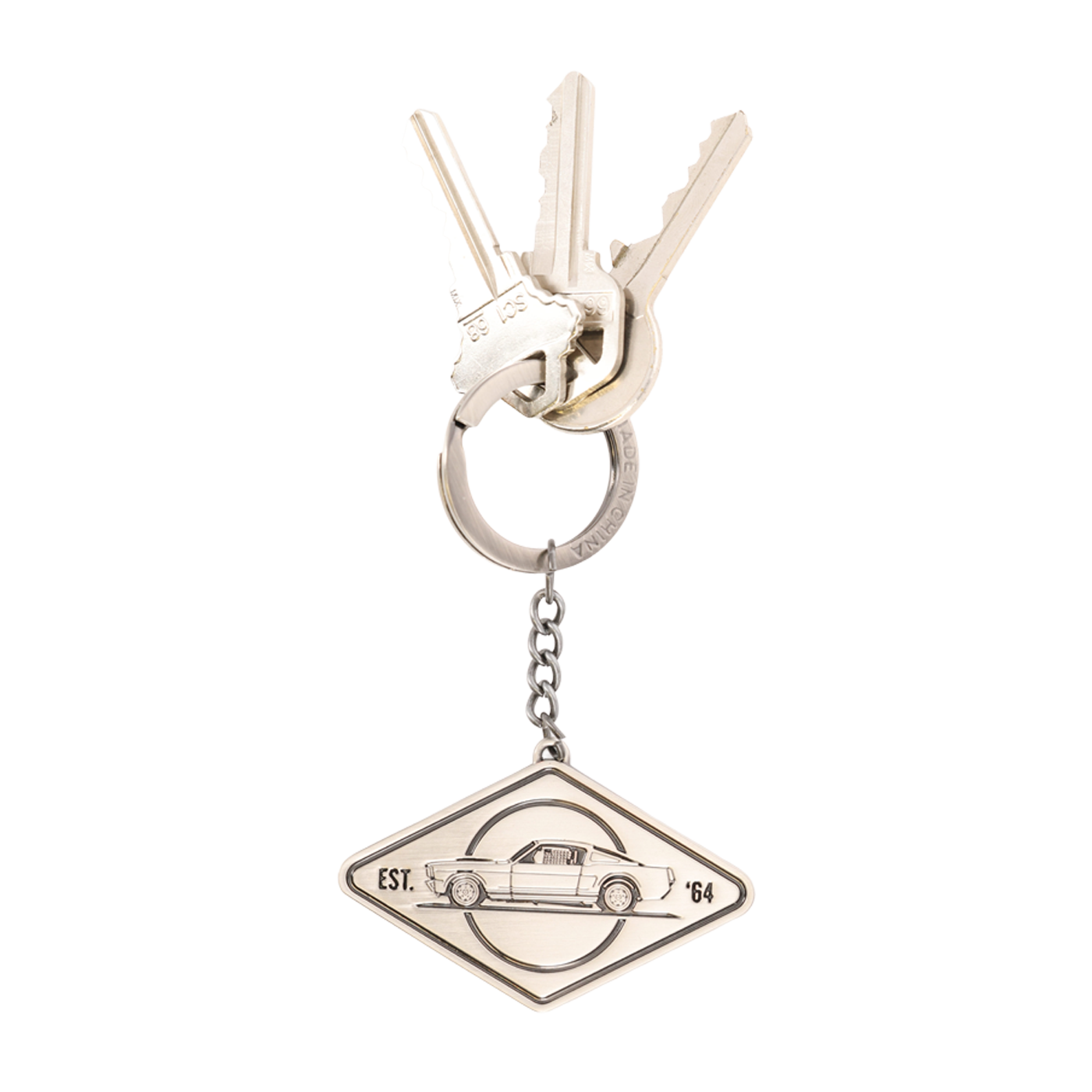 Silver keychain with a car emblem on a white background