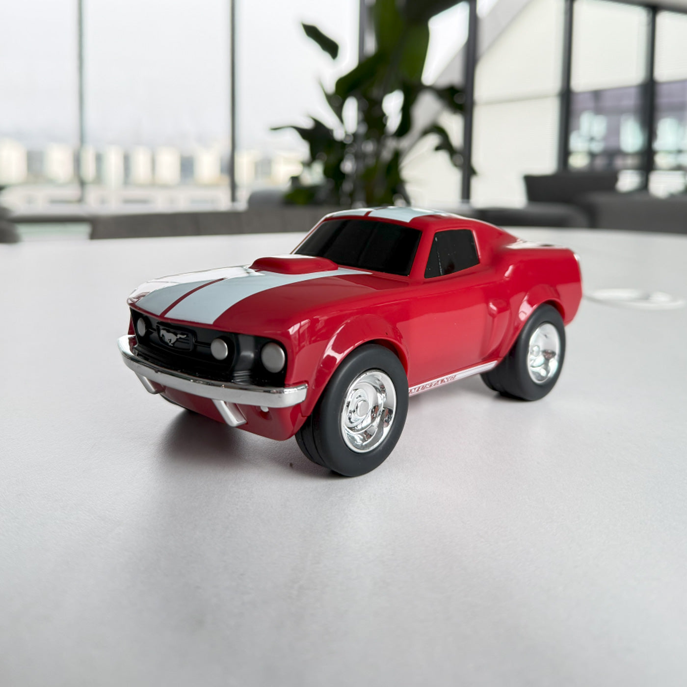White and red mustang muscle car Bagheera toy model on a white counter top