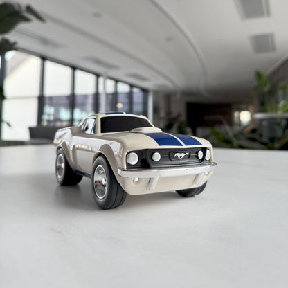 White and blue mustang muscle car Bagheera toy model on a white counter top