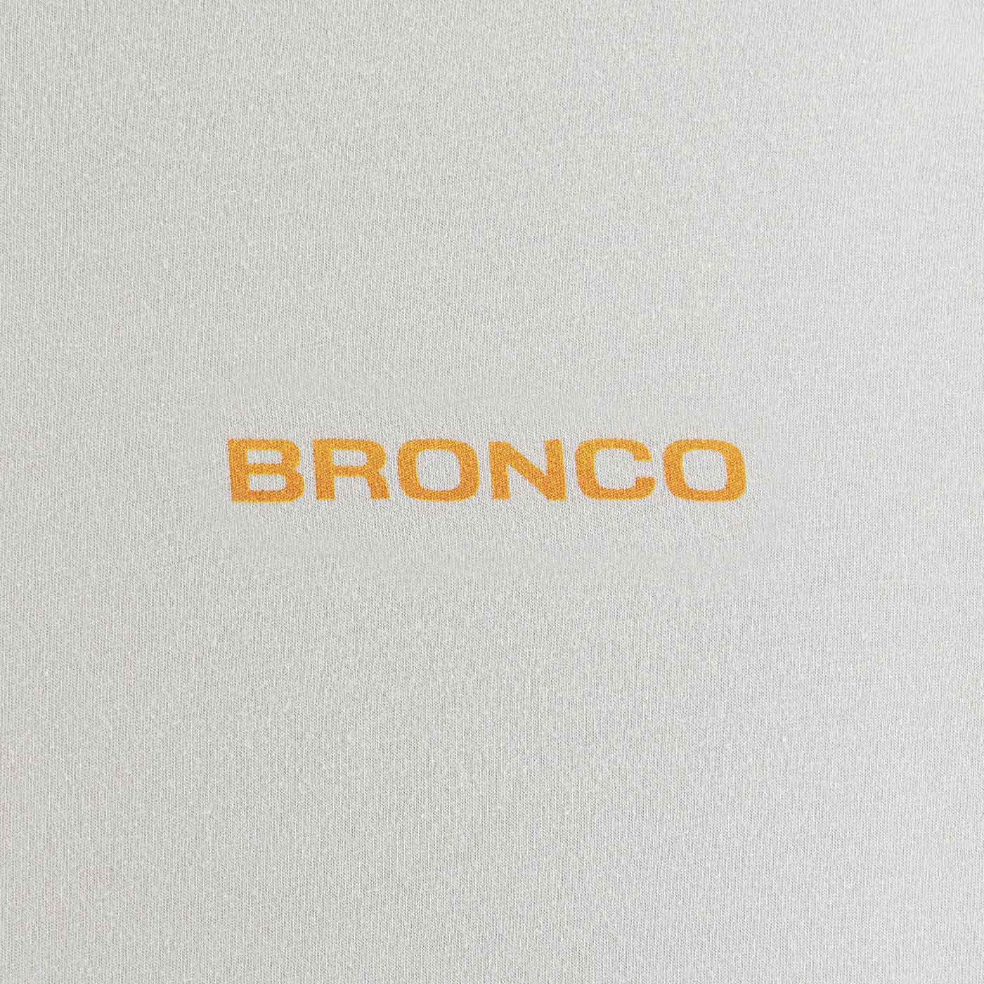 Text 'BRONCO' in orange on a textured gray background