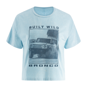 A blue women's t-shirt with a graphic print of a Ford Bronco and the text 'BUILT WILD BRONCO'. The shirt is displayed on a white background.