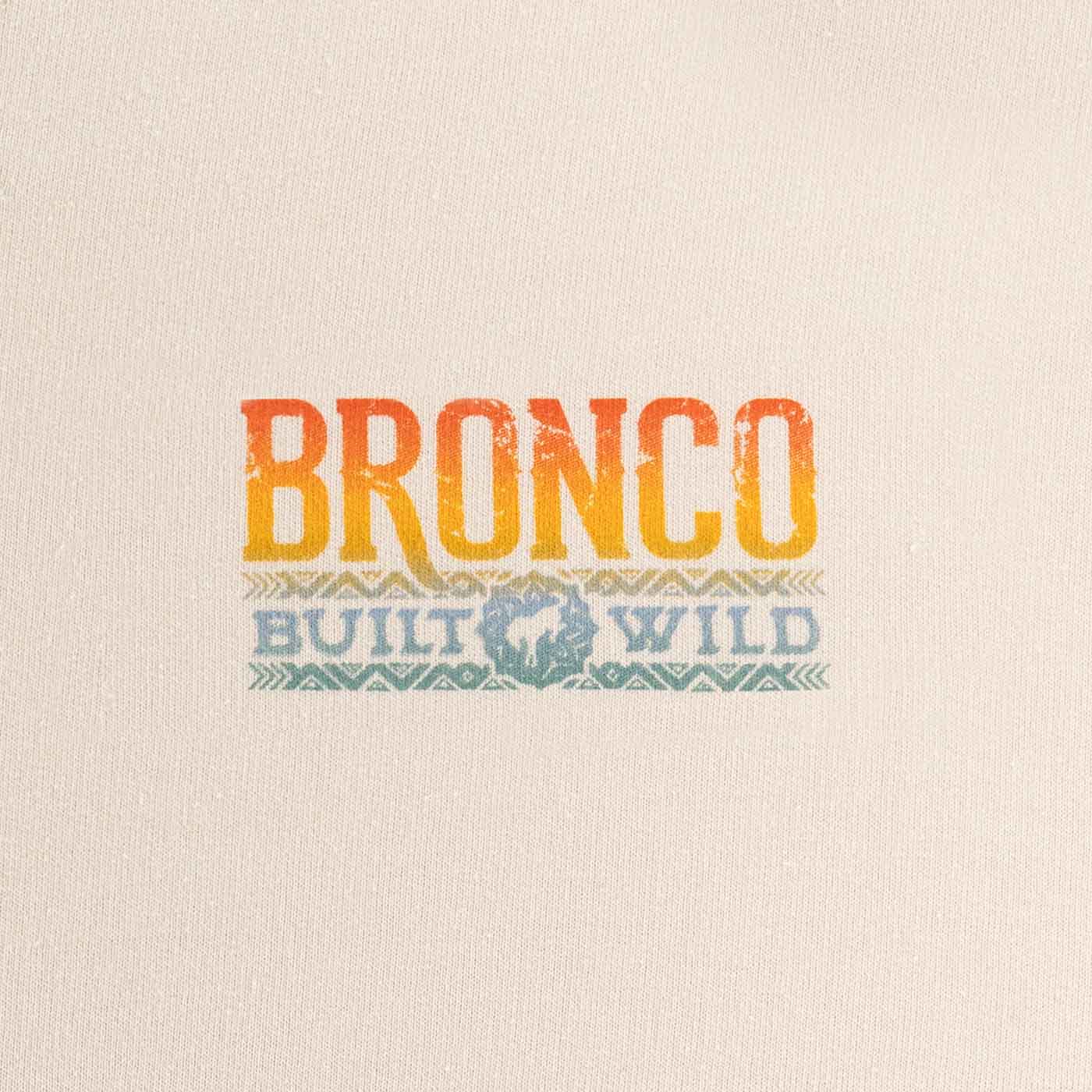 close up of multicolor ombre bronco built wild text on cream background