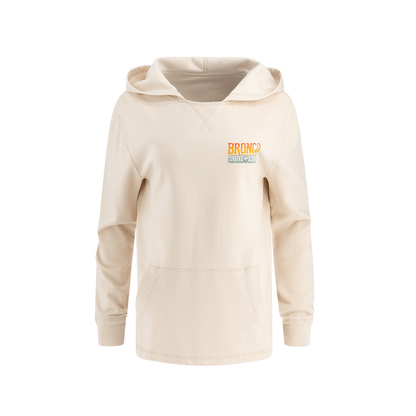 front of cream beach style women's hoodie with bronco built wild ombre multicolor emblem on front left chest