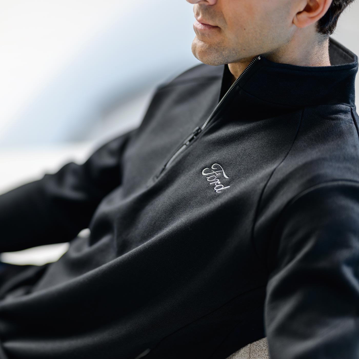 man in black ford script collard quarter ziip