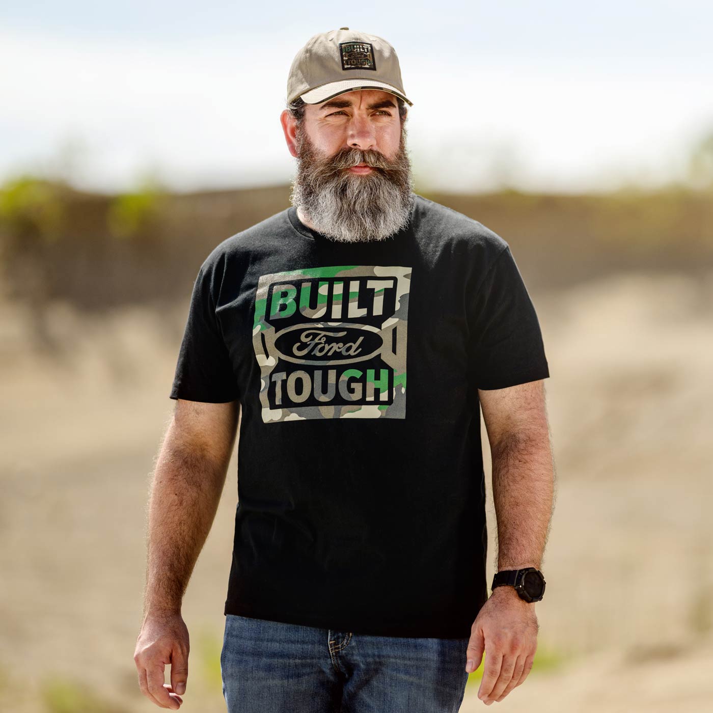 Man wearing a black 'Built Ford Tough' t-shirt outdoors