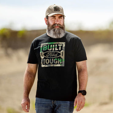 Man wearing a black 'Built Ford Tough' t-shirt outdoors