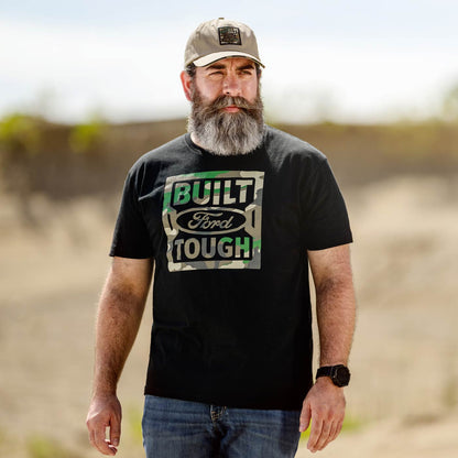 Man wearing a black 'Built Ford Tough' t-shirt outdoors