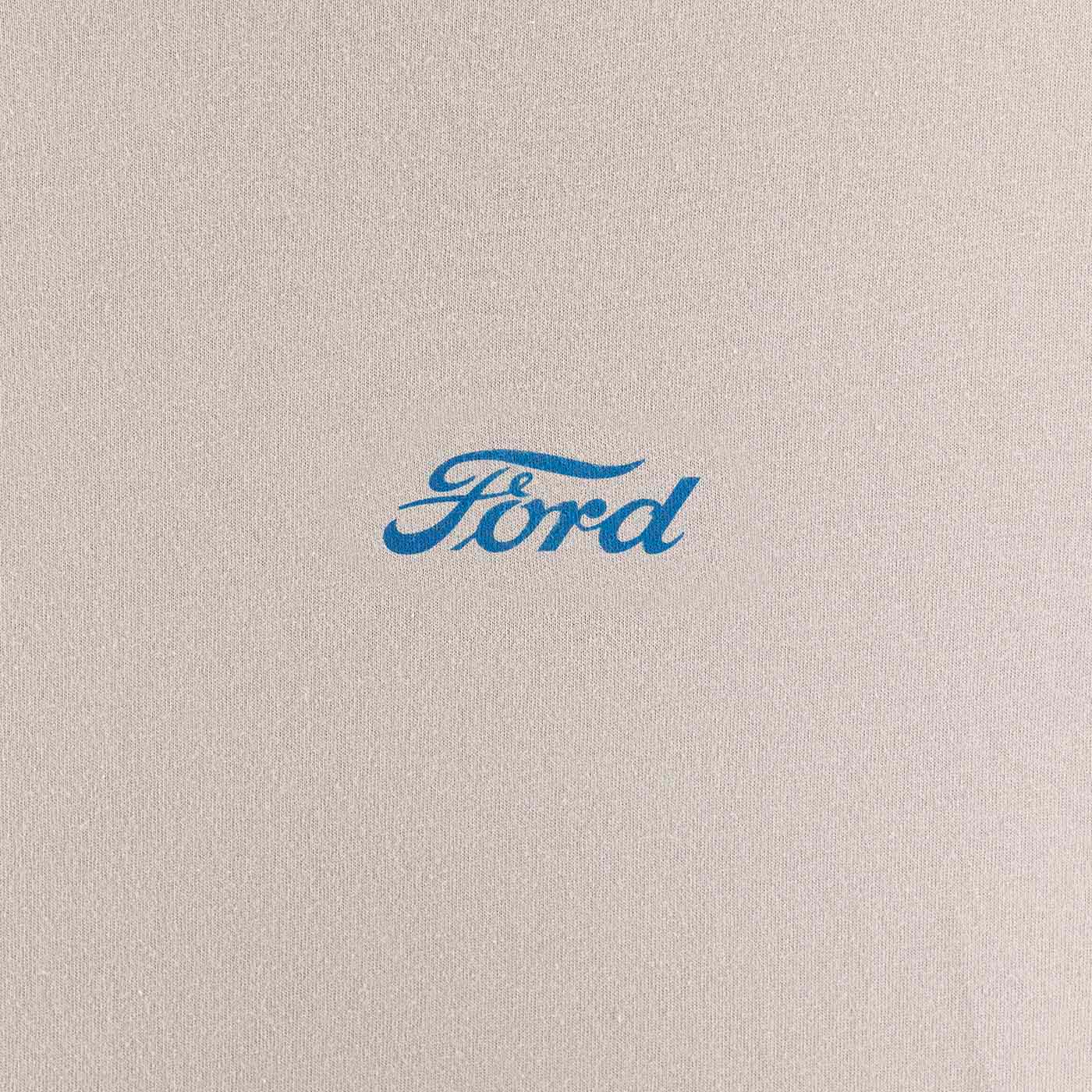 close up of blue ford script on a silver background