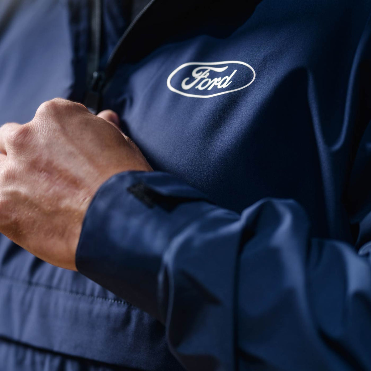 Navy blue jacket with Ford logo on a blurred background