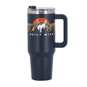 white bucking bronco in front of mountains and sun graphic with Built wild script on navy blue tumbler with handle