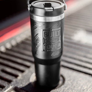 Black travel mug with 'Built Ford Tough' engraving on a textured surface