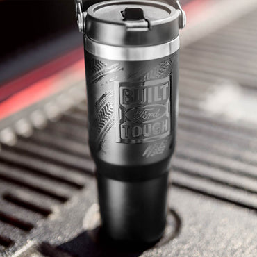 Black travel mug with 'Built Ford Tough' engraving on a textured surface