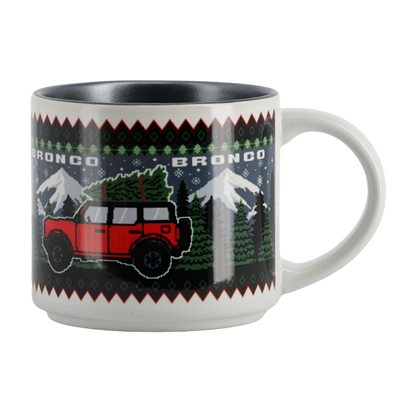 Mug with a red Bronco graphic and Christmas tree on a patterned background
