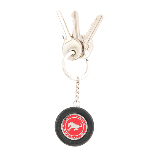 Keychain with a red and black logo on a white background