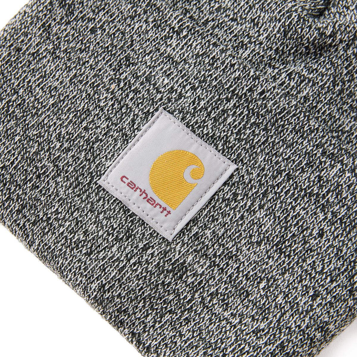 Close-up of a Carhartt label on a textured fabric background