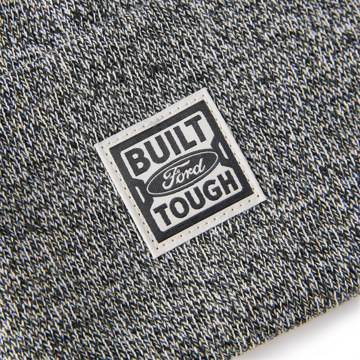 Close-up of a 'Built Ford Tough' label on textured fabric.