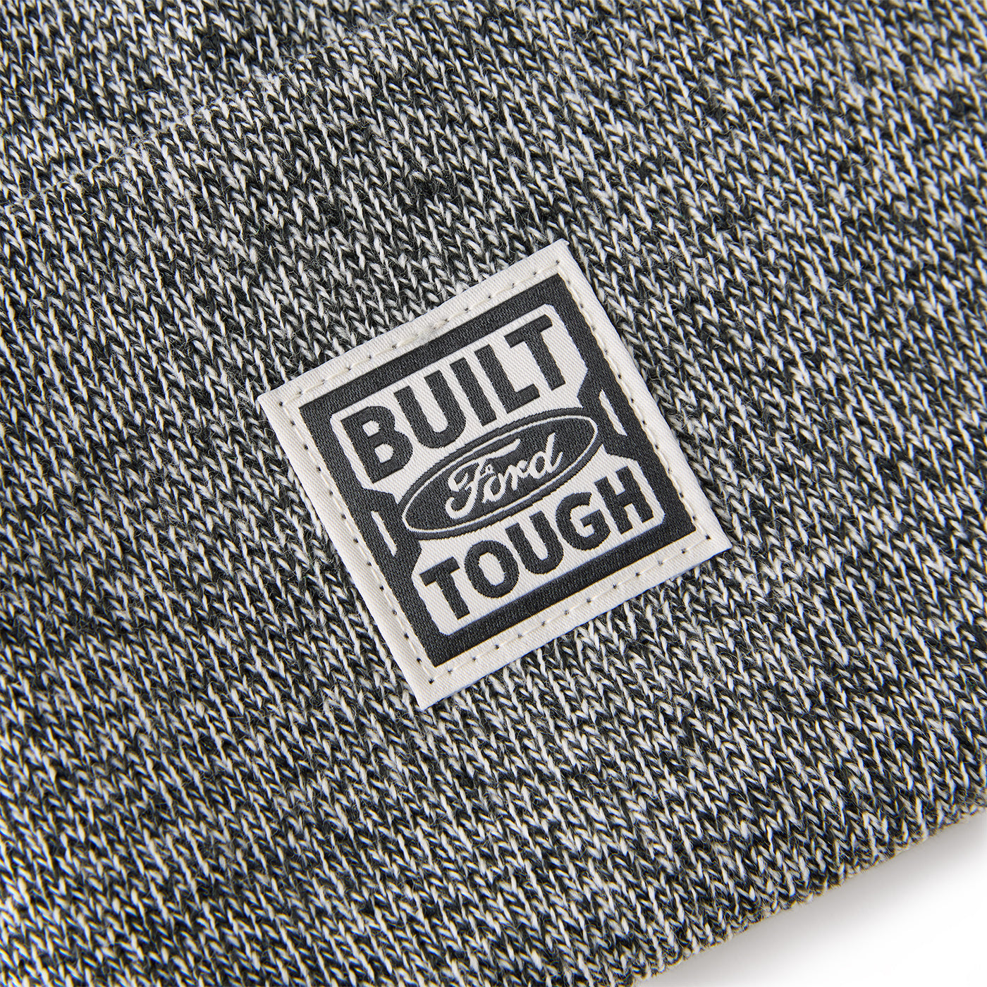Close-up of a 'Built Ford Tough' label on textured fabric.