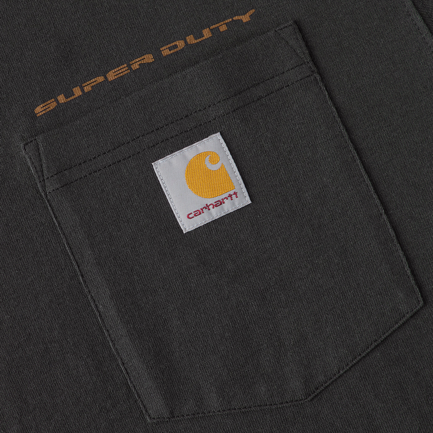 Close-up of a black pocket with 'Super Duty' text and Carhartt logo.