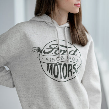 Person wearing a gray hoodie with Ford Motors logo