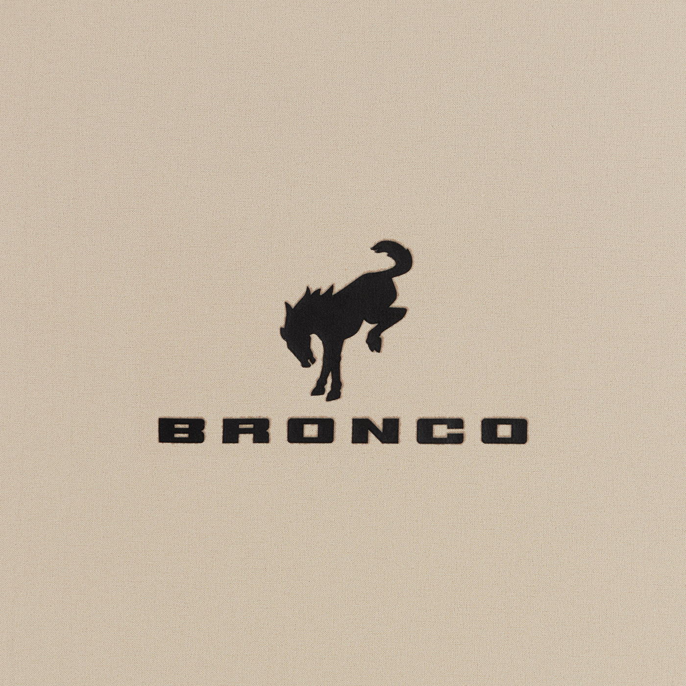 Bronco logo with a horse silhouette on a beige background