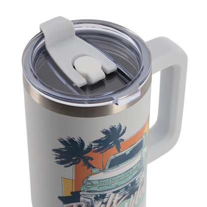 Travel mug with handle and lid featuring a palm tree and car design on a white background