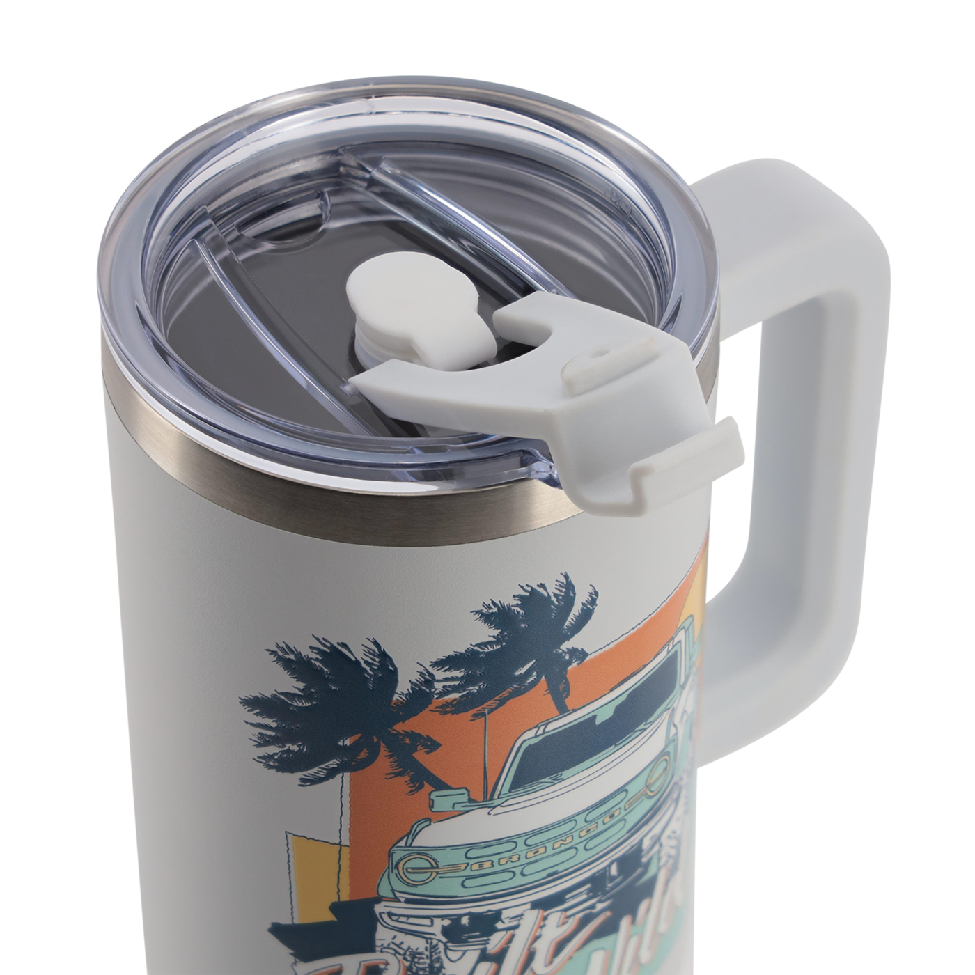 Travel mug with handle and palm tree design on a white background