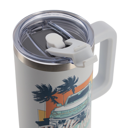 Travel mug with handle and palm tree design on a white background