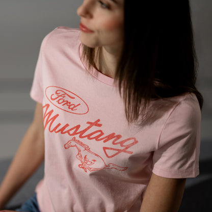 Person wearing a pink t-shirt with Ford Mustang logo