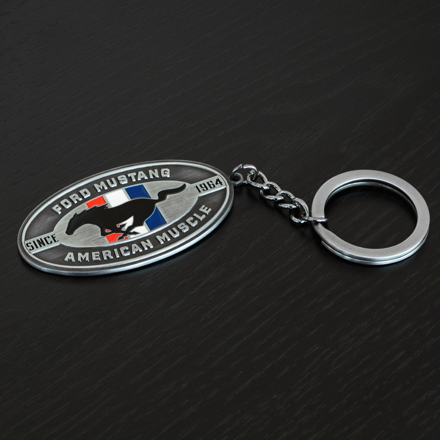 Ford Mustang keychain on a dark textured background