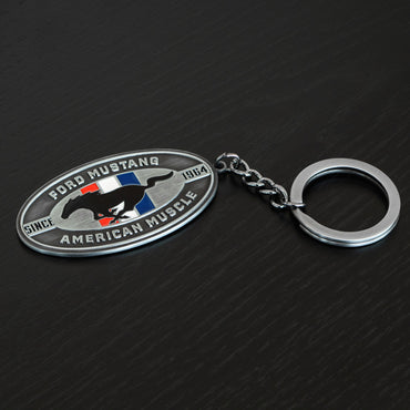 Ford Mustang keychain on a dark textured background