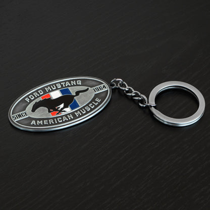 Ford Mustang keychain on a dark textured background