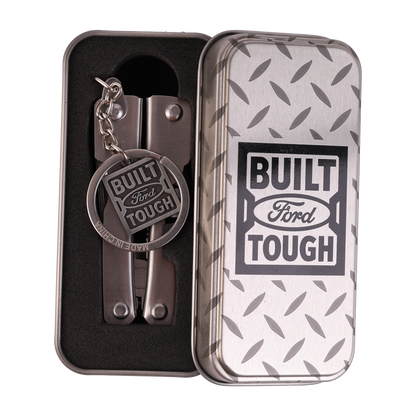 Multitool keychain with 'Built Ford Tough' tag in a branded tin box.