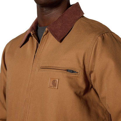 Close-up of a person wearing a brown Carhartt work jacket with a dark brown corduroy collar and a zippered chest pocket.