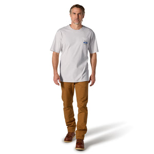 A man modeling a light gray short-sleeve pocket t-shirt with a small blue and white logo on the chest pocket, paired with brown pants and brown shoes, against a plain white background.